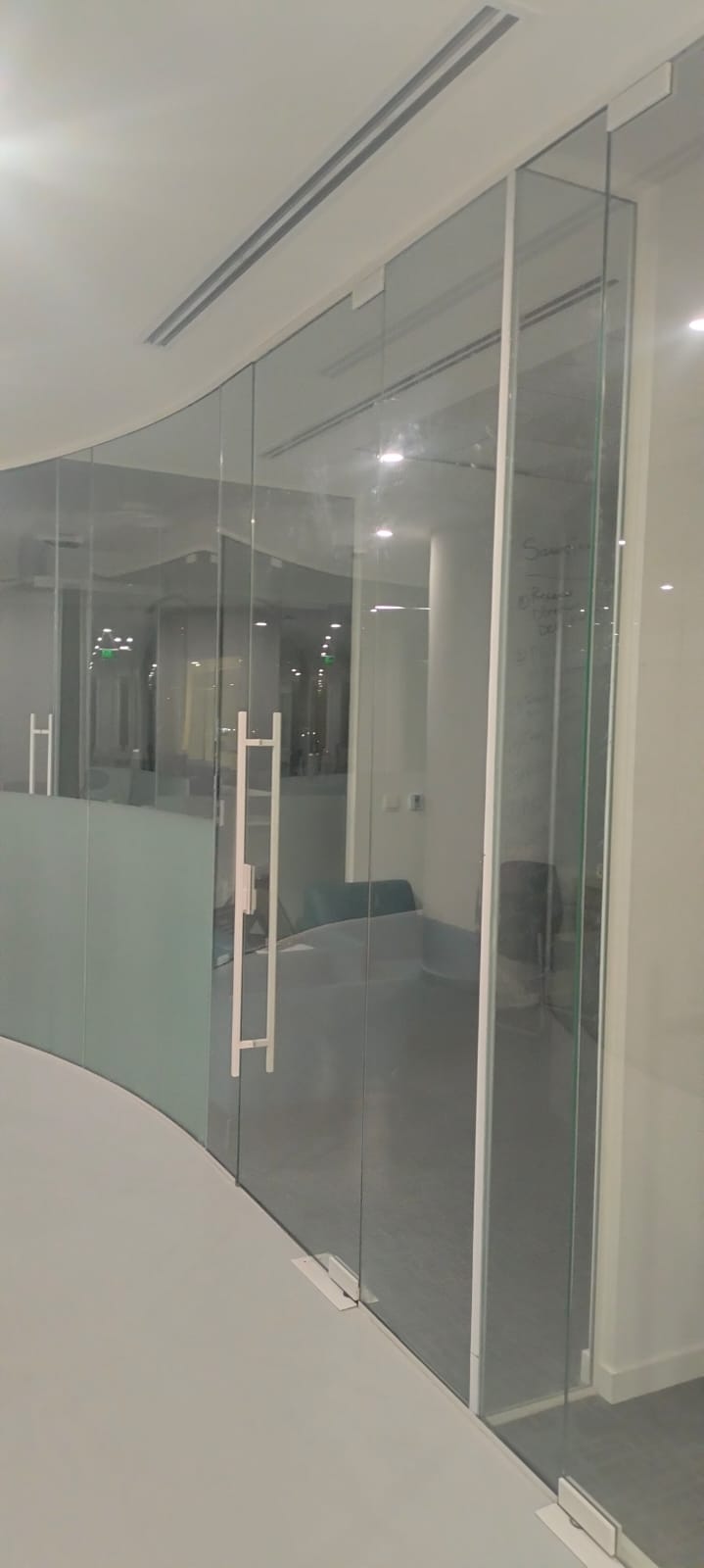 Curved frameless glass office partition with doors