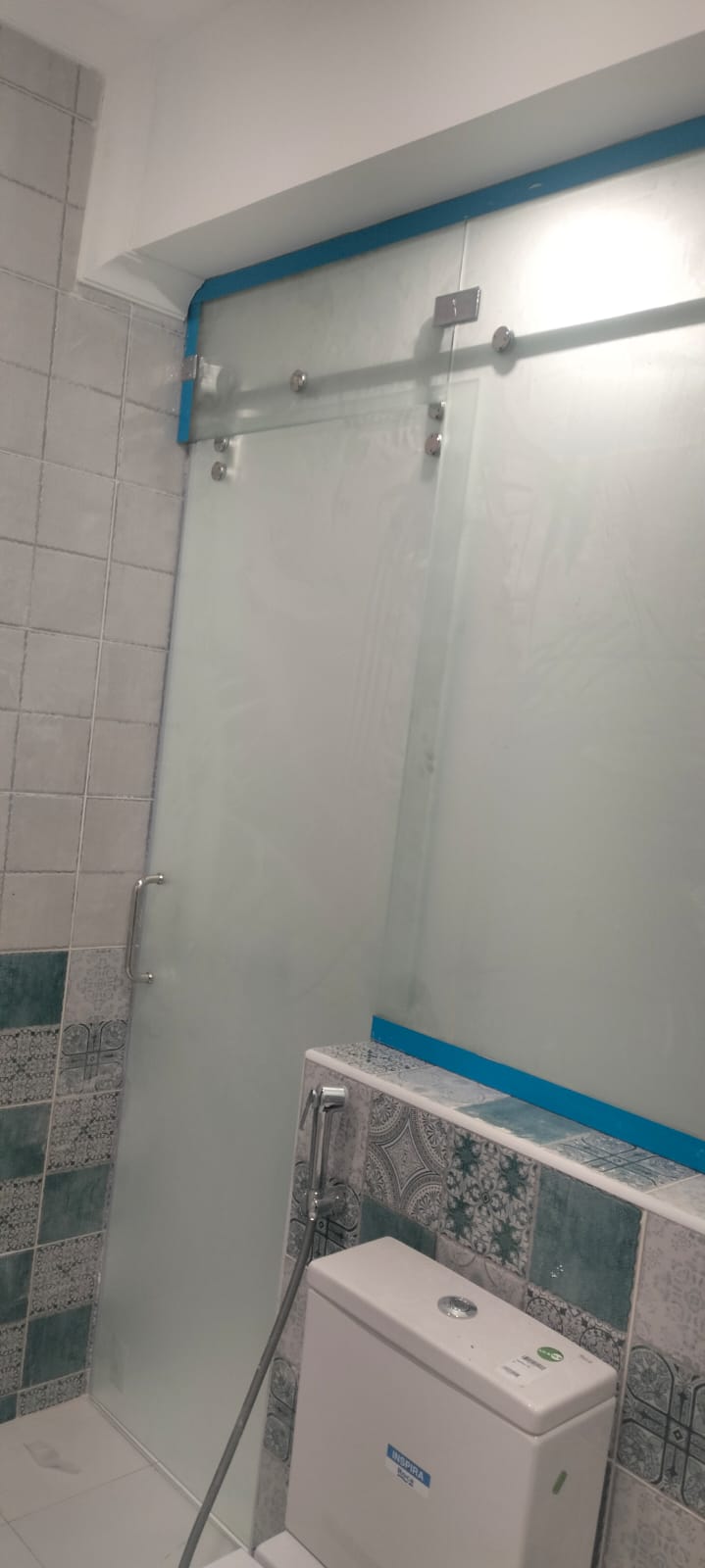 Frosted sliding shower door installation